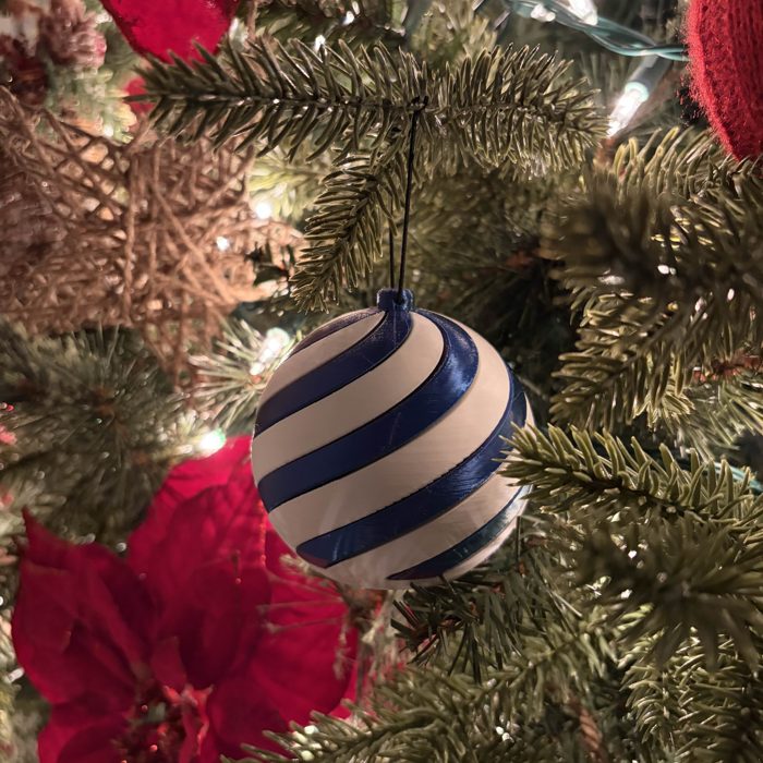 3D printed spiral ornament hanging on a Christmas tree